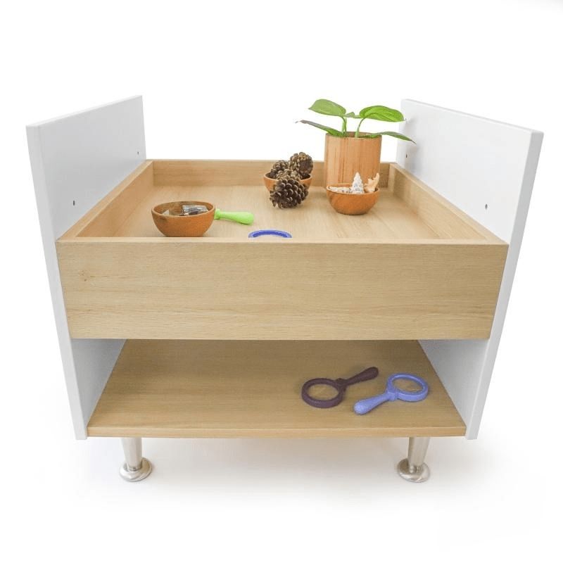 Whitney Brothers elevatED Toddler Discovery Table showing the full-perimeter raised lip that keeps toys and materials securely on the toddler activity table surface during active play