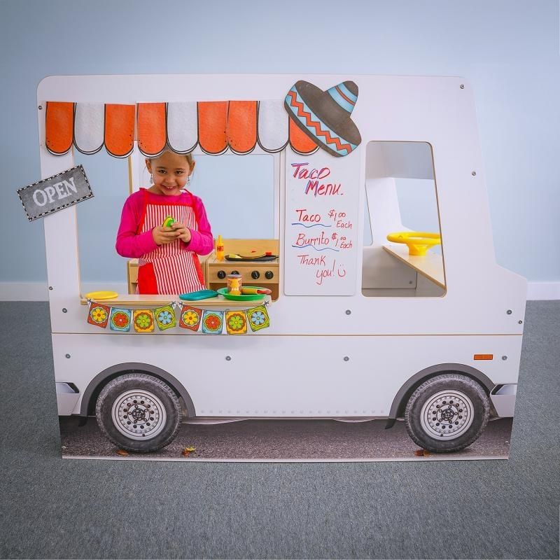 Child in the interior work area of the Whitney Brothers Imagination Truck, showing the middle play space designed to accommodate a play stove, sink, or fridge