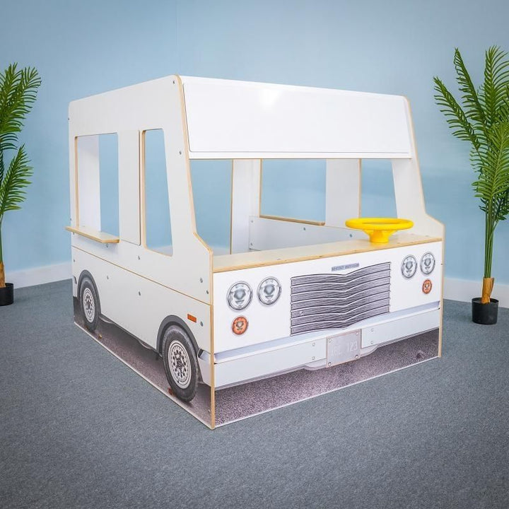 Empty interior view of the Whitney Brothers Imagination Truck showing the three play zones: driver/passenger front area, middle work area, and side-panel serving counters