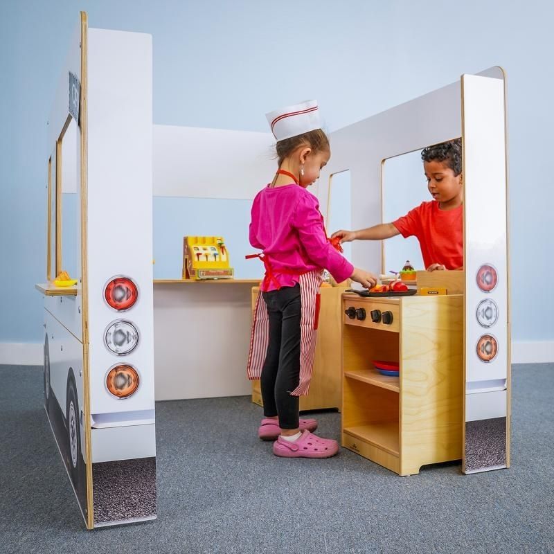 Rear view of the Whitney Brothers Imagination Truck with children playing as crew and customers simultaneously, demonstrating the open adult-visibility design of the role play vehicle