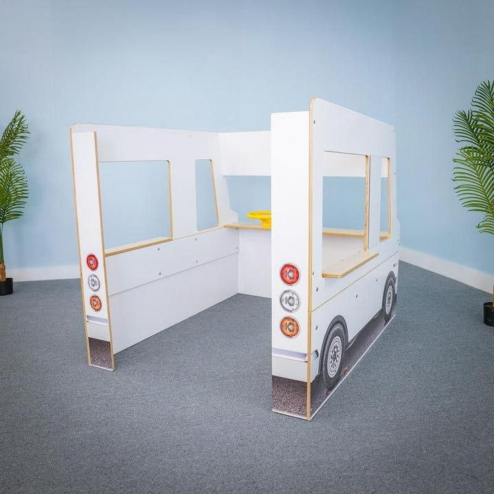 Rear empty view of the Whitney Brothers Imagination Truck showing the open adult-supervision design, serving counters, and dry erase side panel boards of the classroom role play vehicle