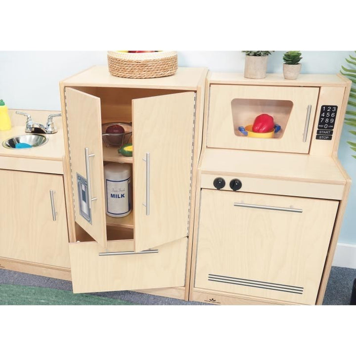 Close-up view of the Whitney Brothers Contemporary Kitchen Ensemble Natural showing an open cabinet door with matte chrome handle and the full-length continuous piano hinge safety feature
