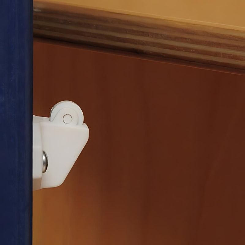 Close-up of a safety hinge on the Whitney Brothers Monaco Combo Kitchen Playset, showing the continuous hinge design that prevents finger pinching during play