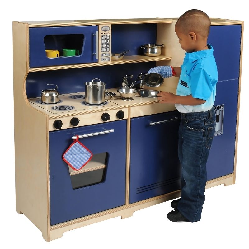 Child actively playing with the Whitney Brothers Monaco Kitchen 3-Piece Playset, a wooden dramatic play kitchen for classrooms and home