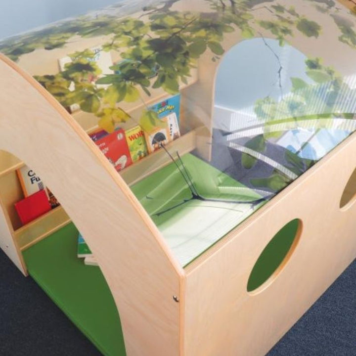 Top-down view of the Whitney Brothers Nature Reading Haven showing the curved shatterproof acrylic tree canopy roof printed with a realistic tree canopy image and the optional Green Floor Mat inside