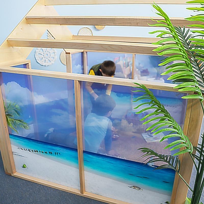 Top and side view of the Whitney Brothers Nature View Play Beach House showing the open pergola-style roof structure and the detail of the ocean beach scene on the acrylic panels below