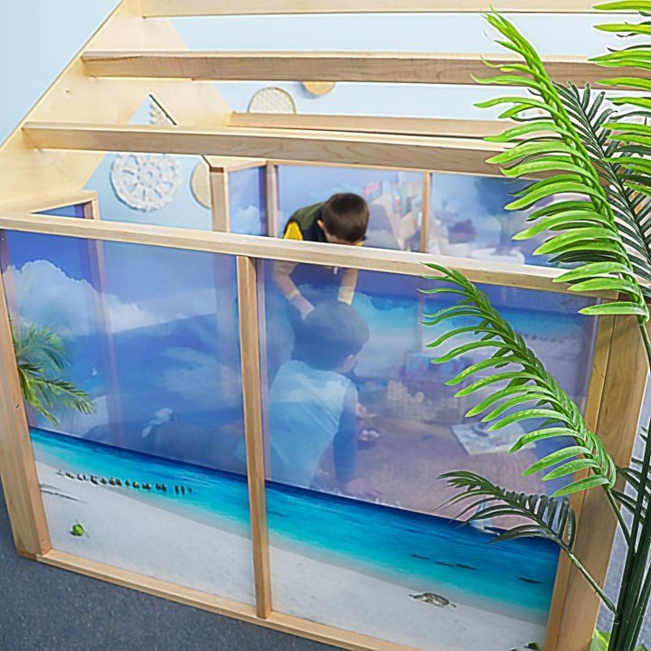 Top and side view of the Whitney Brothers Nature View Play Beach House showing the open pergola-style roof structure and the detail of the ocean beach scene on the acrylic panels below