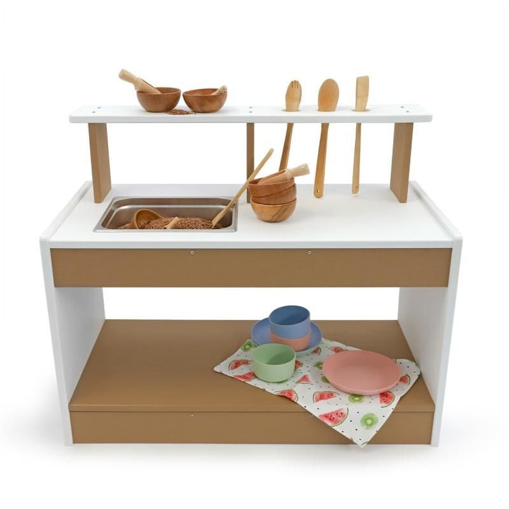 Whitney Brothers outdoorED Mud Kitchen front view with pots, pans, and play tools organised on shelves, showing outdoor sensory play kitchen in active use