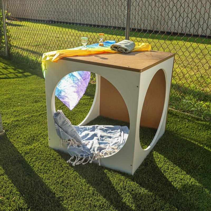 Whitney Brothers outdoorED outdoor play house cube landscape view in outdoor classroom setting showing full two-tone woodgrain maple and polar white HDPE profile