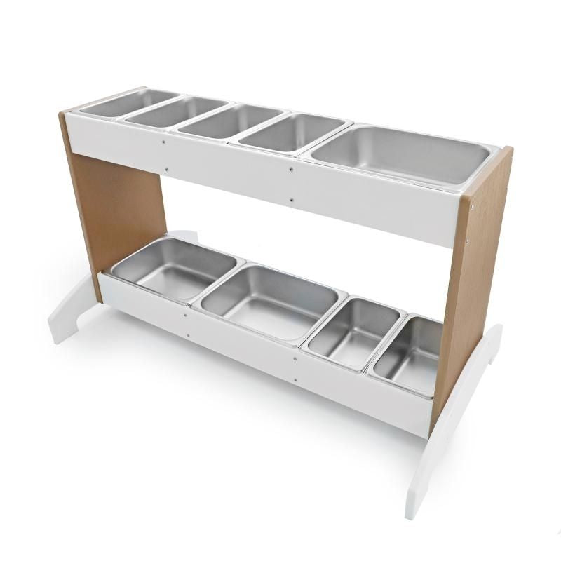 Top view of Whitney Brothers outdoorED outdoor potion station showing nine interchangeable stainless steel trays arranged across top and bottom rails with woodgrain maple and polar white HDPE finish