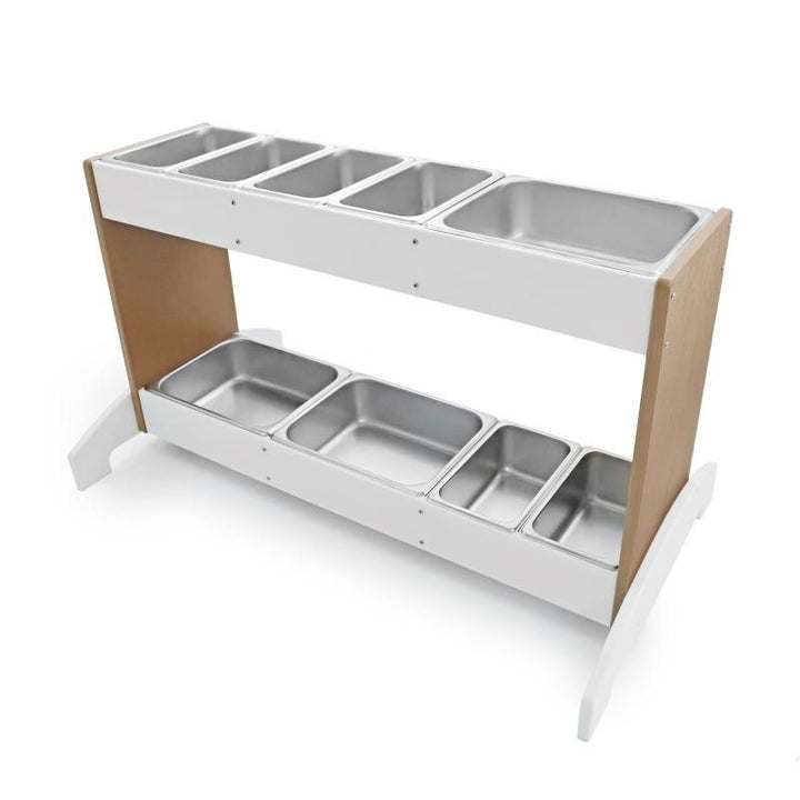 Top view of Whitney Brothers outdoorED outdoor potion station showing nine interchangeable stainless steel trays arranged across top and bottom rails with woodgrain maple and polar white HDPE finish
