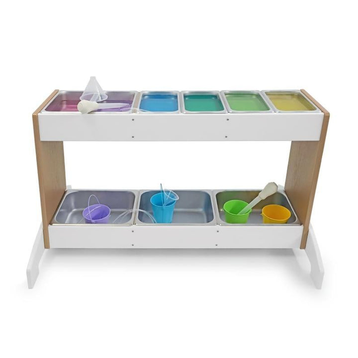 Whitney Brothers outdoorED Potion Station portrait view with coloured materials in stainless steel trays, showing outdoor STEM sensory play station in active preschool use
