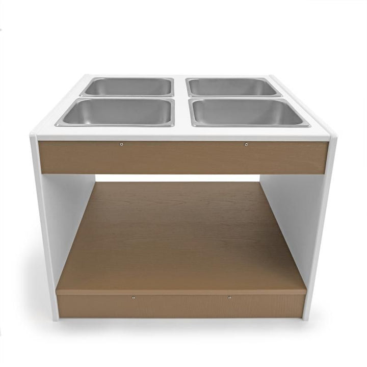 Whitney Brothers outdoorED Sensory Table clean front view showing four surface-mounted stainless steel trays, lower storage shelf, and two-tone woodgrain maple and polar white design