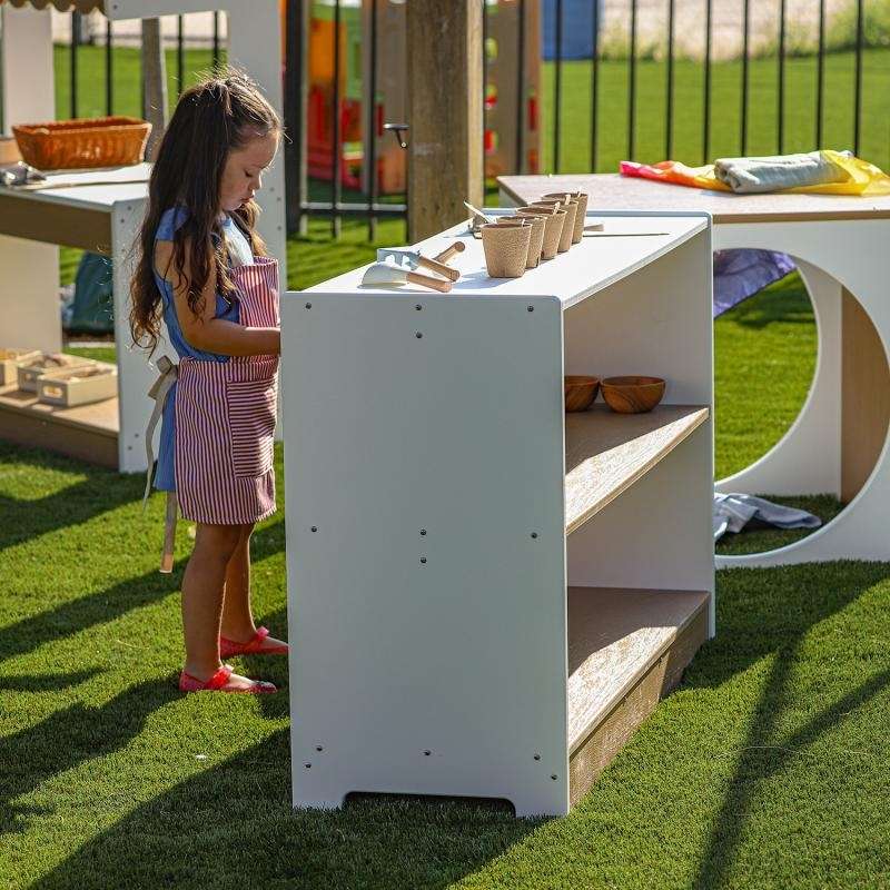 Child interacting with the outdoored storage for outdoor classrooms and preschool learning spaces