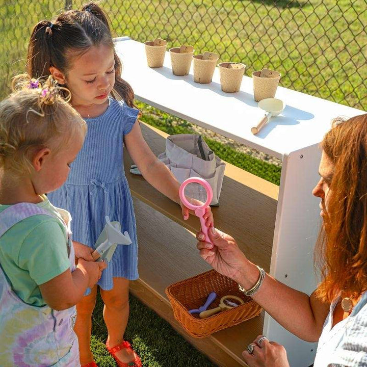Whitney Brothers outdoorED Storage Shelf two children and one adult interaction with the outdoored storage   outdoor setting