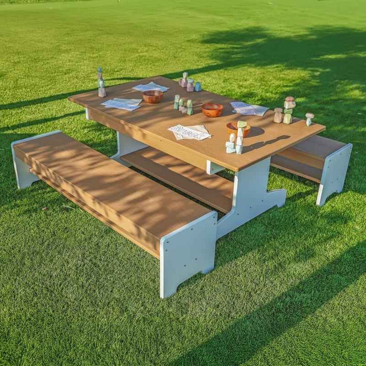 Whitney Brothers outdoorED Table and Two Benches Set photographed from above in an outdoor garden learning environment, showing full three-piece layout