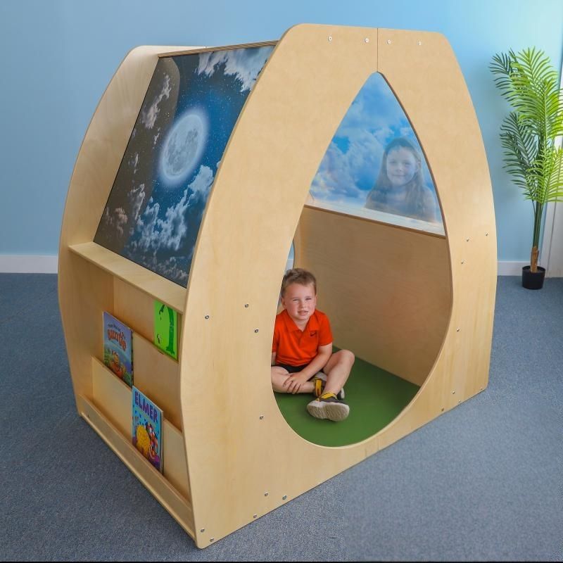 Child playing inside the Whitney Brothers Sky View Sanctuary showing the shatterproof acrylic sky panels, curved openings, and the biophilic day and night sky imagery of the reading nook