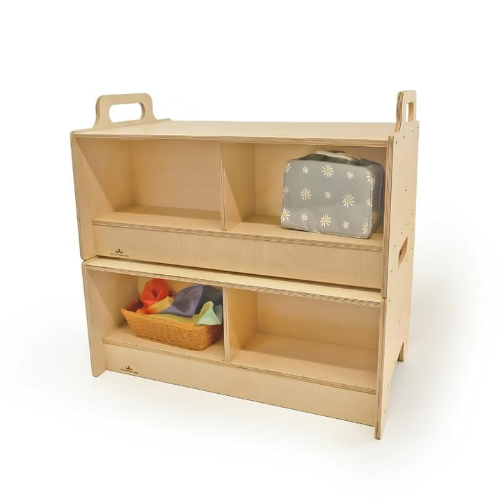 Whitney Brothers Stack-Able Benches stacked into a two-sided storage cabinet with classroom materials organised across four open compartments, showcasing flexible early learning furniture storage