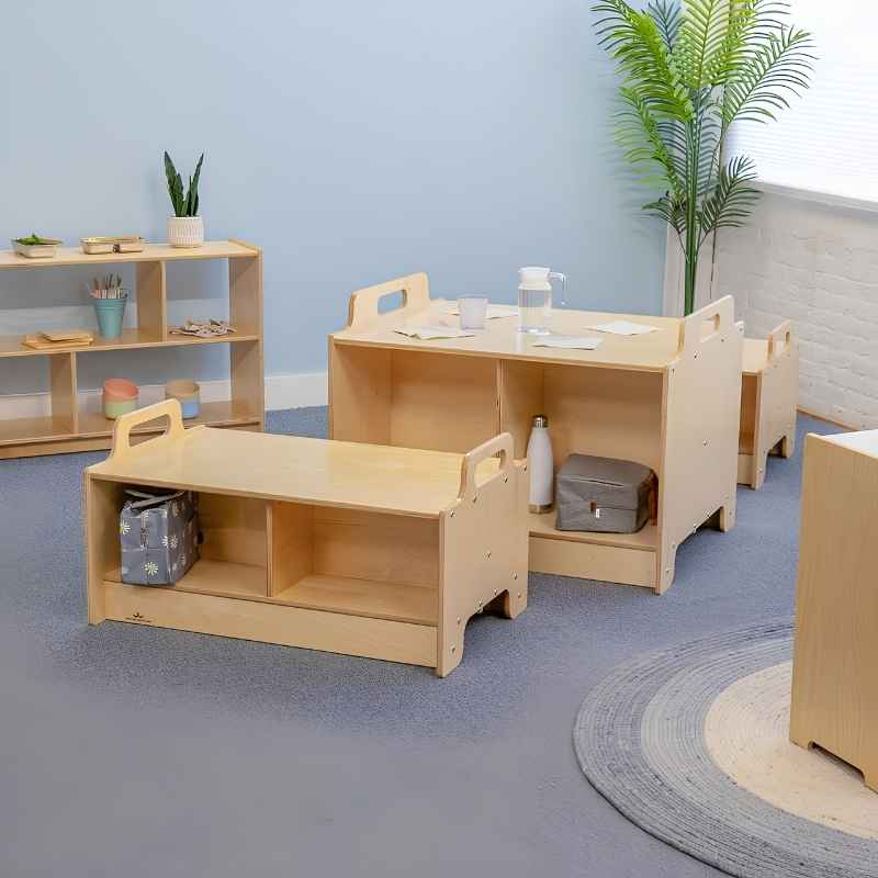 Whitney Brothers Stack-Able Collection arranged in an early learning classroom, showing the Stack-Able Bench and Stack-Able Table configured as a flexible multi-functional learning environment with integrated storage