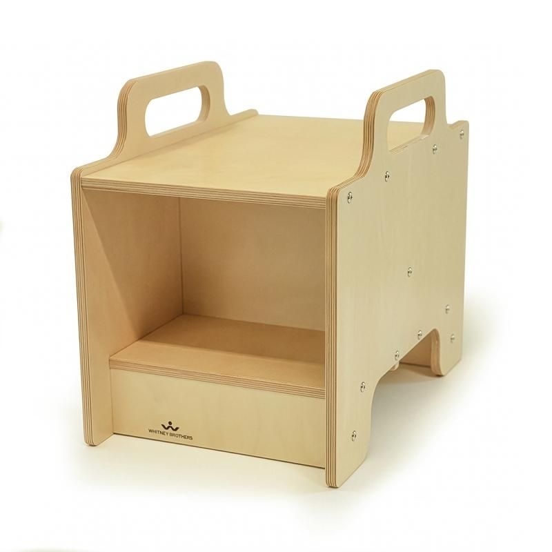 Whitney Brothers Stack-Able Seat in birch plywood on white background, showing the open storage compartment, raised seating surface, and hand-hold cutouts at the top for easy repositioning in preschool and classroom settings