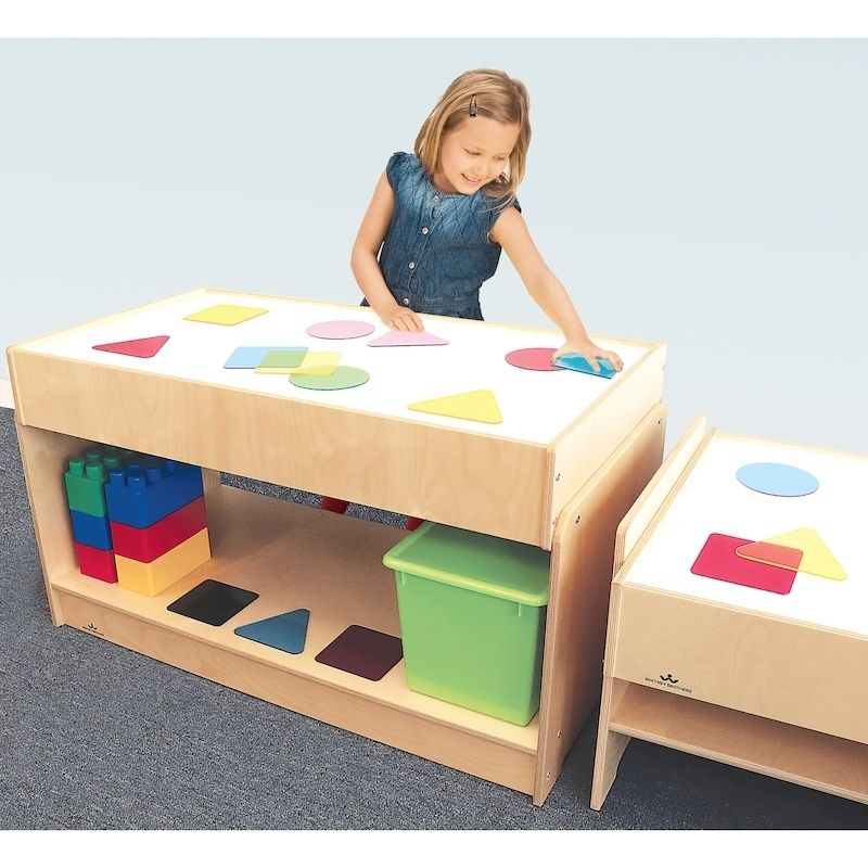 Children using the Whitney Brothers Superbright LED Sensory Light Table Large during active play, showing the illuminated surface with translucent sensory materials