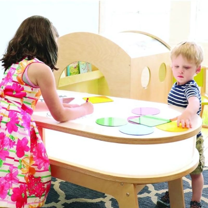 Two children using the Whitney Brothers Whitney Plus Radiant LED Light Table simultaneously, showing the elongated 47" design that accommodates collaborative group light table activities