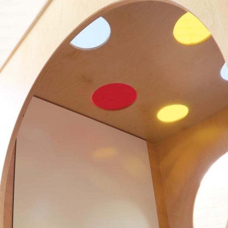 Interior view of the Whitney Brothers Whitney Plus Porthole Play House Cube showing the non-ghosting dry-erase marker board and tray mounted on the back wall of the private play space