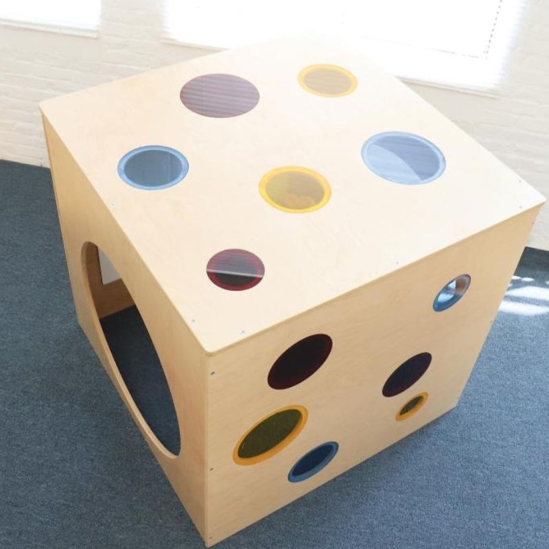 Top-down view of the Whitney Brothers Whitney Plus Porthole Play House Cube showing the colourful acrylic portholes in random sizes across the top panel of the 40"x40" play cube